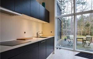 a kitchen with a sink and a large window at Amazing Home In Græsted With Kitchen in Græsted