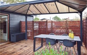 a patio with a table and chairs on a deck at Beautiful Home In Børkop With Wifi in Børkop +11 photos