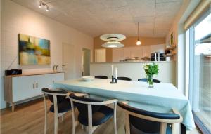a kitchen and dining room with a table and chairs at Beautiful Home In Børkop With Wifi in Børkop
