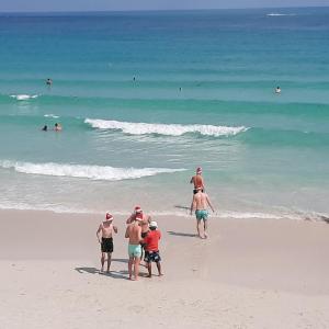a group of people standing on a beach at Sunrise Resort- Koh Phangan - SHA Extra Plus in Haad Rin