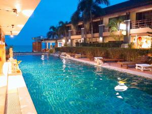 a swimming pool in front of a hotel at Sunrise Resort- Koh Phangan - SHA Extra Plus in Haad Rin