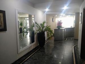 a hallway with potted plants in a building at Filadelfia Hotel in São Paulo