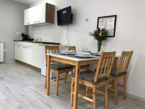a kitchen with a wooden table and chairs at Apartment Portorose in Portorož
