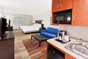 a hotel room with a kitchen and a living room at Holiday Inn Express Hotel & Suites Montgomery Boyd-Cooper Parkway by IHG in Montgomery