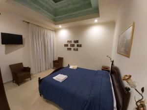 a bedroom with a blue bed in a room at B&B il Baglio in Nicotera