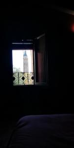 a bedroom with a window with a view of a tower at Casa Aljez in Calatayud
