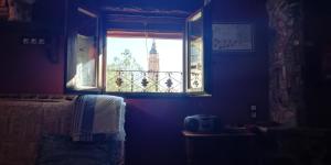 a bedroom with a window with a view of a tower at Casa Aljez in Calatayud