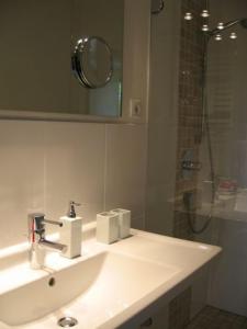 a bathroom with a white sink and a shower at Haus Dürresbach in Hennef
