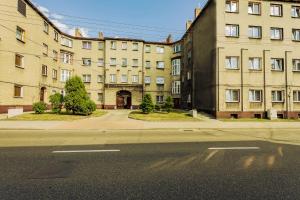 an empty street in front of a large building at Stylowy apartament in Katowice