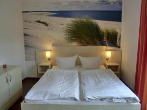 a bedroom with a bed with a picture of a beach at Fewo mit Terrasse in Gelbensande