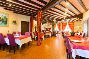 a restaurant with tables and chairs in a room at Relais d'Auvergne in Saint-Gervais-dʼAuvergne