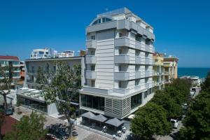 an apartment building in front of the ocean at Hotel Gala in Misano Adriatico