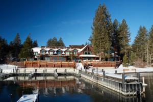 a row of boats docked at a dock in front of a house at Sunnyside Resort and Lodge in Tahoe City