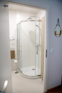 a bathroom with a shower with a glass door at Rejaillir in Saint-Ours