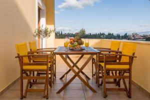 a dining room with a table and chairs with a view at Louisa's Summer House in Kastanéa
