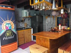 a kitchen with a refrigerator and a counter in it at Hostel Rota 027 Itacaré in Itacaré