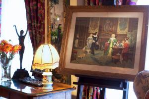 a living room with a painting on the wall at Hotel Left Bank Saint Germain in Paris