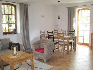 a living room with a table and chairs at Ferienhaus auf dem Hof Lechner in Drieschnitz