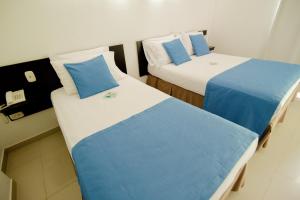 Voodi või voodid majutusasutuse Hotel Maranata Valledupar toas