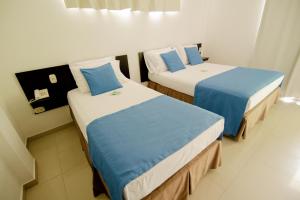 Voodi või voodid majutusasutuse Hotel Maranata Valledupar toas