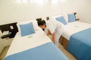 Ένα ή περισσότερα κρεβάτια σε δωμάτιο στο Hotel Maranata Valledupar