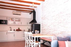 a kitchen and living room with a table and chairs at Apartamento acogedor y exclusivo de Eva in Sant Feliu de Guíxols
