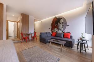 a living room with a blue couch and a table at MAGNOLIA City Suite in Patra