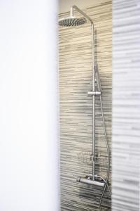 a shower in a bathroom with a shower curtain at MAGNOLIA City Suite in Patra