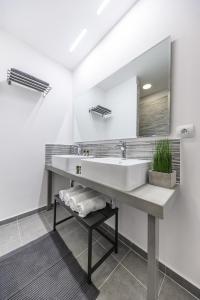 a bathroom with a sink and a mirror at MAGNOLIA City Suite in Patra +66 photos