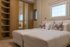 Ένα ή περισσότερα κρεβάτια σε δωμάτιο στο Βόρεια Παραλία