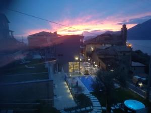 a view of a city at night with the sunset at Locanda San Marco in Torri del Benaco