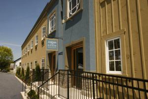 a yellow and blue building with a sign on it at Jordan House Hotel in Jordan