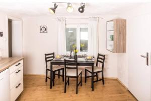 a dining room with a black table and chairs at Lober´s Ferienhaus **** in Bretzenheim