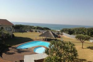 a swimming pool in the yard of a house at Cabanas 64 in Kingsborough