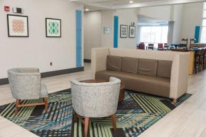 a living room filled with furniture and a rug at Holiday Inn Express Hotel & Suites Columbia-Fort Jackson, an IHG Hotel in Columbia