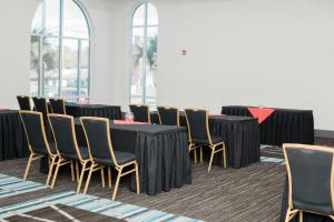 a conference room with a black table and chairs at Holiday Inn Express Hotel & Suites Columbia-Fort Jackson by IHG in Columbia