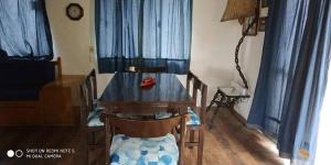 a dining room with a wooden table and chairs at Mi Capricho in Barra de Maldonado