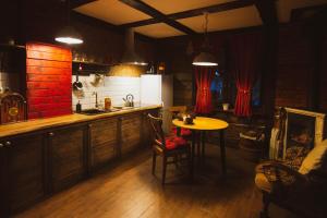 a kitchen with a table and a counter and a table and chairs at Dom Yarla in Janowiec