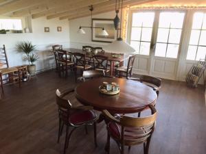 a dining room with wooden tables and chairs at B&B De Mersken in Ureterp