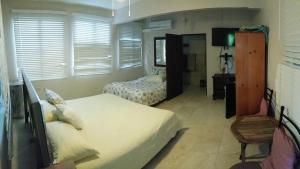 a bedroom with two twin beds and a mirror at Villa Marsana in Aguada