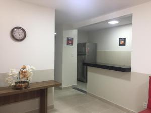 a hallway with a clock and a counter and a refrigerator at Hangar House in Belém +33 photos