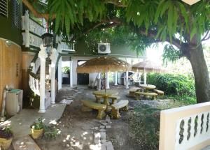 a group of picnic tables and umbrellas in a courtyard at Villa Marsana in Aguada