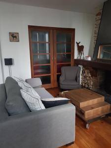 a living room with a couch and a fireplace at VANILLE in Bagnères-de-Bigorre