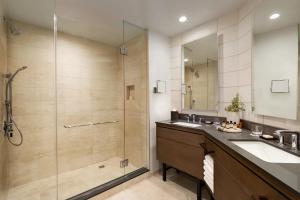 a bathroom with a sink, mirror, and bath tub at Fairmont Scottsdale Princess in Scottsdale