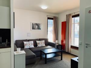 a living room with a couch and a table at Apartmany Jasna Chopok in Demanovska Dolina