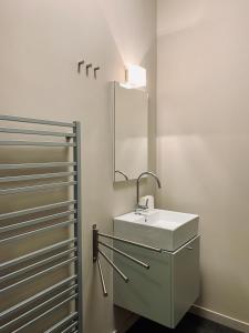 a bathroom with a white sink and a mirror at Apartmany Jasna Chopok in Demanovska Dolina