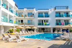 a hotel with a swimming pool and chairs and a building at A Maos Hotel Apartments in Ayia Napa