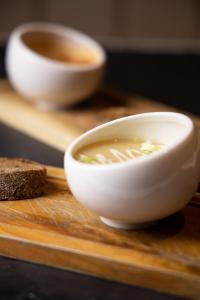 a bowl of soup sitting on a wooden surface at Hotel Millingen in Millingen aan de Rijn