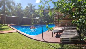 a swimming pool in the backyard of a house at Posada 21 Oranges in Puerto Iguazú
