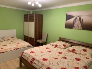 Postel nebo postele na pokoji v ubytování Harmonie Apartments